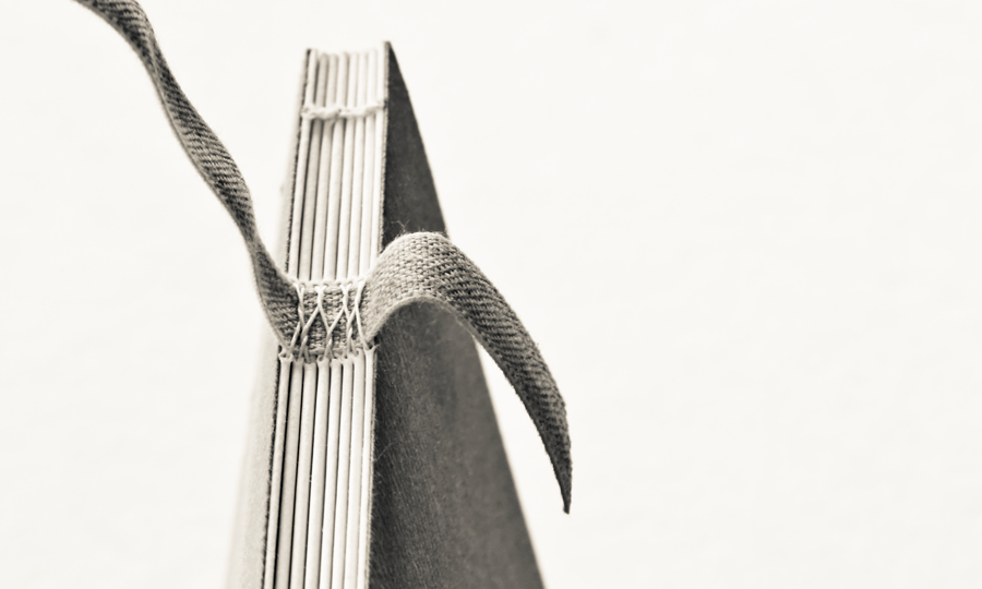 A close-up of the stitching of a bound book